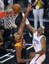 Los Angeles Clippers guard Terance Mann (14) dunks on Utah Jazz center Rudy Gobert, left, during the second half of Game 5 of a second-round NBA basketball playoff series Wednesday, June 16, 2021, in Salt Lake City. (AP Photo/Rick Bowmer)