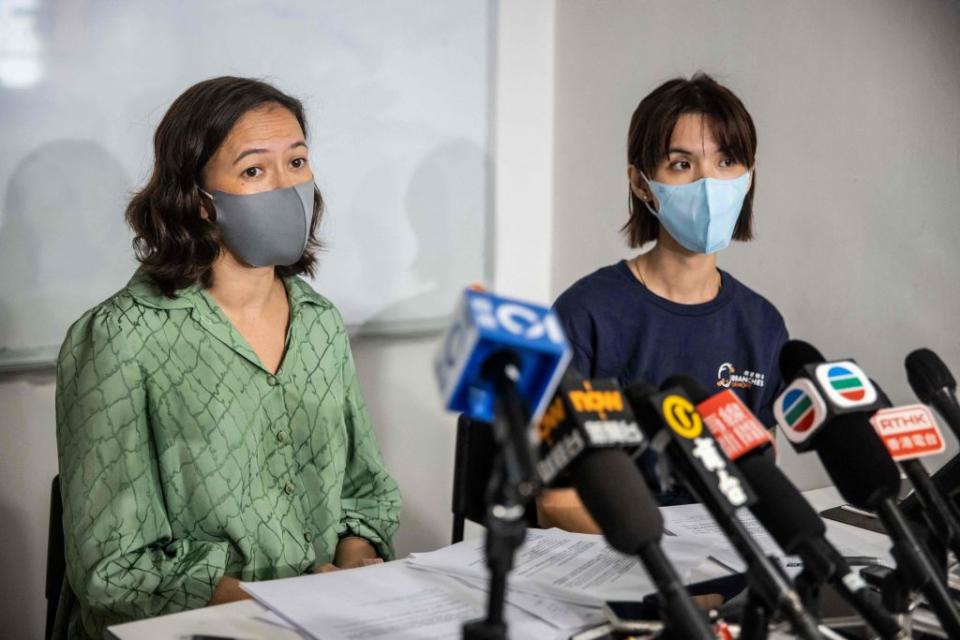 Human rights lawyer Patricia Ho (L) and Programme Manager at STOP, an anti-trafficking NGO, Michelle Wong (R), speak to the media in Hong Kong on August 24, 2022, about Hong Kong residents being trafficked into South East Asia and forced to work in scam syndicates.<span class="copyright">ISAAC LAWRENCE/AFP via Getty Images</span>