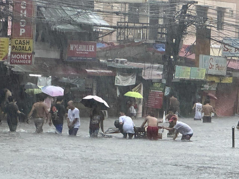 Streets flooded as monsoon rains worsened by offshore typhoon Gaemi on Wednesday, July 24, 2024, in Manila, Philippines. (AP Photo/Joeal Capulitan)