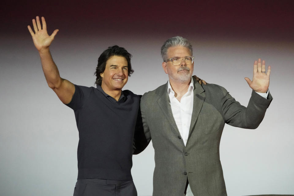 Director Christopher McQuarrie, right, and actor Tom Cruise wave during a news conference for the movie "Mission: Impossible - Dead Reckoning Part One" in Seoul, South Korea, Thursday, June 29, 2023. The film is to be released in the country on July 12. (AP Photo/Lee Jin-man)