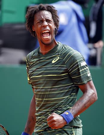 Gael Monfils of France reacts after winning a point during his match against Roger Federer of Switzerland at the Monte Carlo Masters in Monaco April 16, 2015. REUTERS/Eric Gaillard