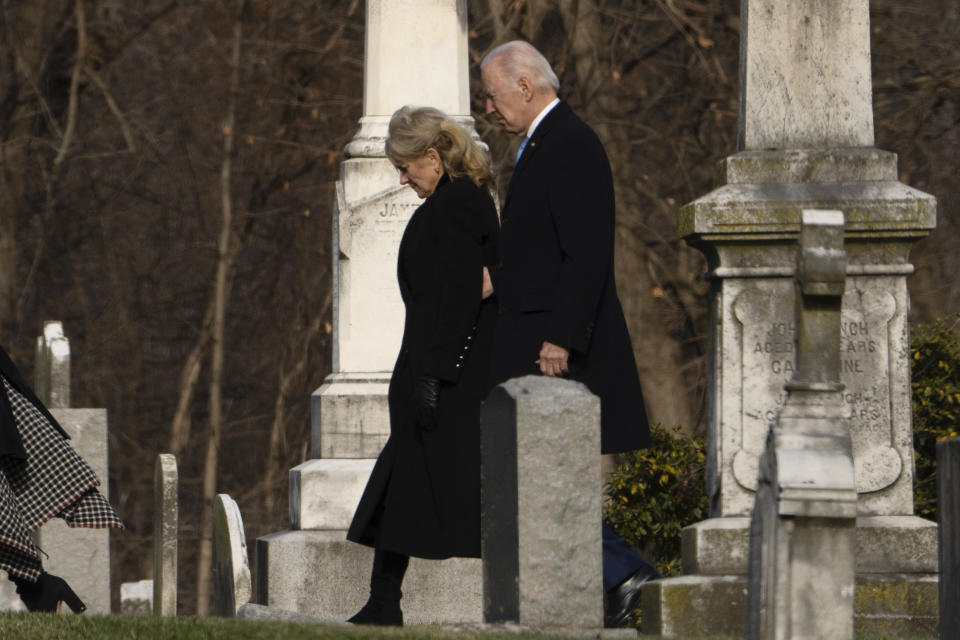 President Joe Biden and first lady Jill Biden walk between tombstones to attend Mass at St. Joseph on the Brandywine Catholic Church in Wilmington, Del., on Sunday, Dec. 18, 2022. Sunday marks the 50th anniversary of the car crash that killed Biden's first wife Neilia Hunter Biden and 13-month-old daughter Naomi. (AP Photo/Manuel Balce Ceneta)