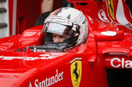 Ferrari Formula One driver Sebastian Vettel of Germany concentrates as he sits in his car during the second practice session of the Monaco Grand Prix in Monaco May 21, 2015. REUTERS/Robert Pratta