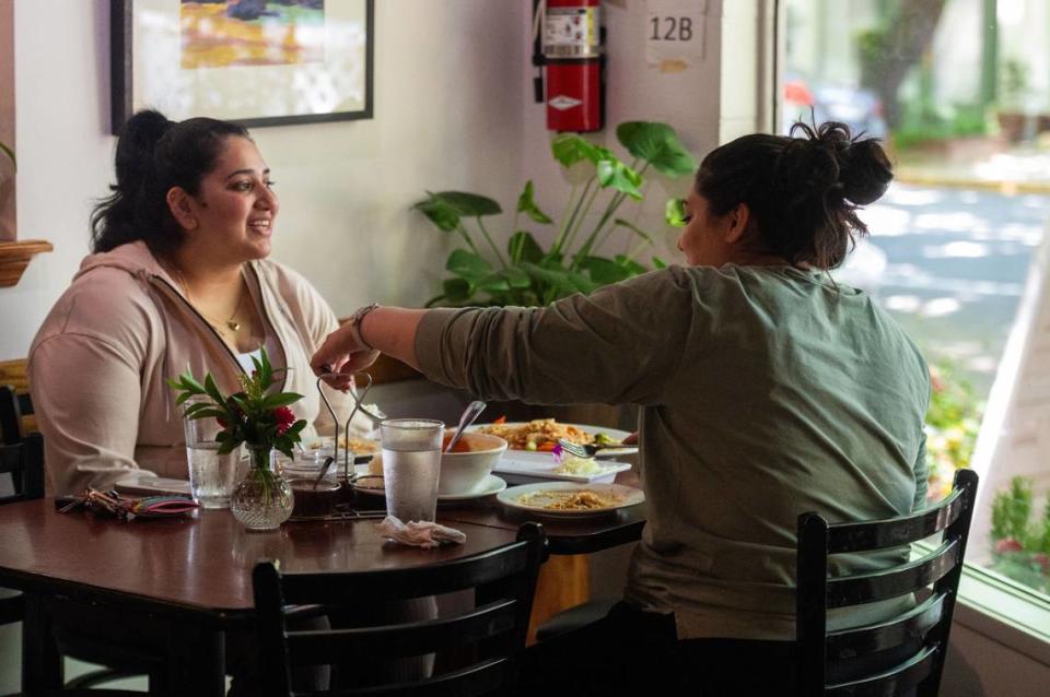 Farheen Afzal and Javairia Rizwan share a meal at Coconut on T Street in Sacramento earlier this month. The two are new customers who recently discovered the restaurant.