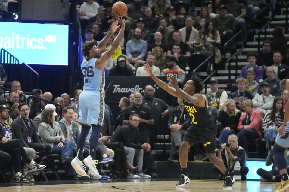 Memphis Grizzlies guard Marcus Smart (36) shoots as Utah Jazz guard Collin Sexton (2) defends during the first half of an NBA basketball game Wednesday, Nov. 1, 2023, in Salt Lake City. (AP Photo/Rick Bowmer)