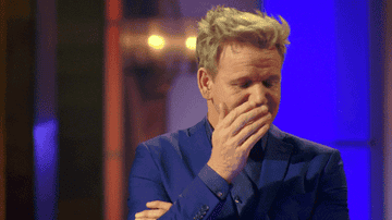 Gordon Ramsay covering his face with his hand