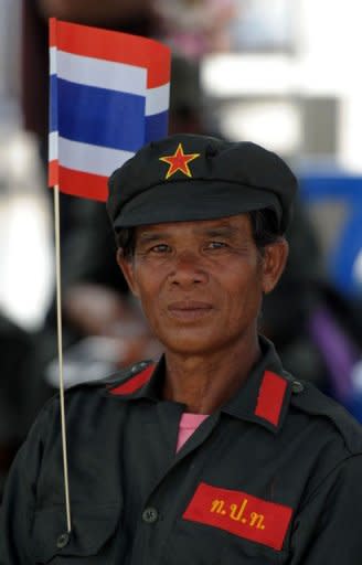 A Thai anti-government protester joins a gathering outside the Thail Constitutional Court prior to a court ruling on whether plans by Prime Minister Yingluck Shinawatra's party to amend the constitution are legal, in Bangkok on July 13, 2012