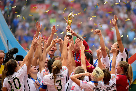 United States players react as they receive the FIFA Women's World Cup trophy after defeating Japan in the final of the FIFA 2015 Women's World Cup at BC Place Stadium. Mandatory Credit: Anne-Marie Sorvin-USA TODAY Sports