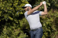 Dustin Johnson tees off on the fourth hole during the final round of the Genesis Invitational golf tournament at Riviera Country Club, Sunday, Feb. 21, 2021, in the Pacific Palisades area of Los Angeles. (AP Photo/Ryan Kang)