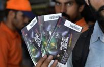 A Pakistani cricket fan holds tickets for the Pakistan and Zimbabwe cricket series after purchase at a shopping mall in Lahore on May 16, 2015