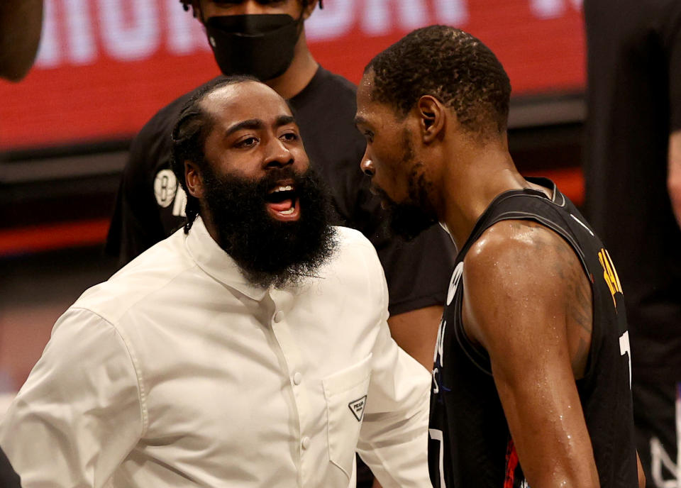 NEW YORK, NEW YORK - JUNE 07:  James Harden #13 of the Brooklyn Nets congratulates teammate Kevin Durant #7 after the third quarter against the Milwaukee Bucks during game two of the Eastern Conference second round series at Barclays Center on June 07, 2021 in the Brooklyn borough of New York City. NOTE TO USER: User expressly acknowledges and agrees that, by downloading and or using this photograph, User is consenting to the terms and conditions of the Getty Images License Agreement. (Photo by Elsa/Getty Images)