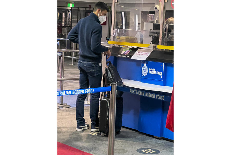 Serbia's Novak Djokovic, the Australian Open defending champion, waits at an Australian Border Force desk on his arrival at Melbourne Airport, Wednesday, Jan. 5, 2022. Locked in a dispute over his COVID-19 vaccination status, Djokovic was confined to the immigration detention hotel in Australia on Thursday, Jan 6, as he awaited a court ruling on whether he can compete in the Australian Open later this month. (AP Photo)