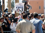 <p>O.J. Simpson (R) walks past members of the media and supporters before he was driven away from the Clark County Detention Center in Las Vegas, Nev., on Sept. 19, 2007 after being released from jail on bail. Simpson was freed from a Las Vegas jail after a judge granted him $125,000 bail on charges he took part in an armed robbery of his own sports memorabilia. (Photo: Rick Wilking/Reuters) </p>