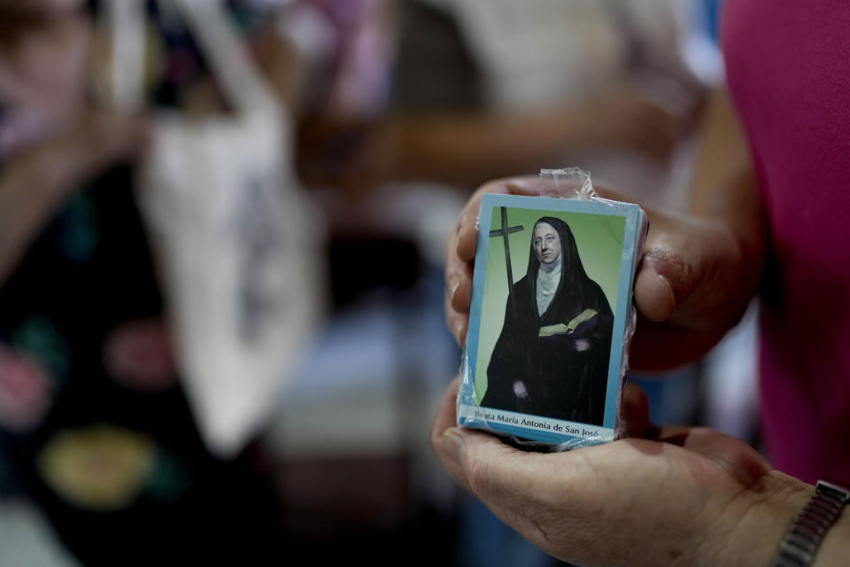 A woman holds a religious holy card with an image of María Antonia de Paz y Figueroa, more commonly known by her Quechua name of “Mama Antula,” on the outskirts of Buenos Aires, Argentina, Sunday, Jan. 28, 2024. The canonization of “Mama Antula” in a Feb. 11th ceremony to be presided by Pope Francis at St. Peter's Basilica marks the first time a female from Argentina will become saint. (AP Photo/Natacha Pisarenko)