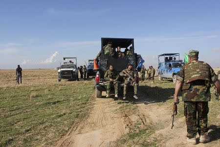 Members of the Iraqi security forces and Shiite fighters take part in an intensive security deployment after clashes with Islamic State militants in Saadiya, Diyala province November 23, 2014. REUTERS/Stringer