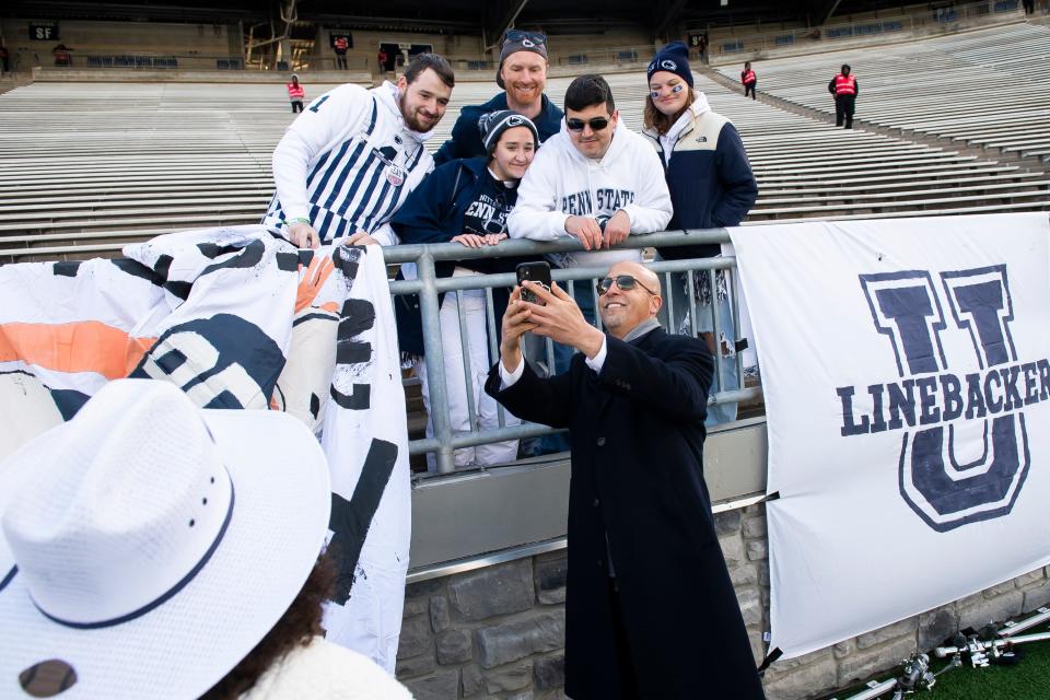 Penn State head football coach James Franklin takes a selfie with a group of fans in the student section at Beaver Stadium before an NCAA football game against Rutgers Saturday, Nov. 18, 2023, in State College, Pa.