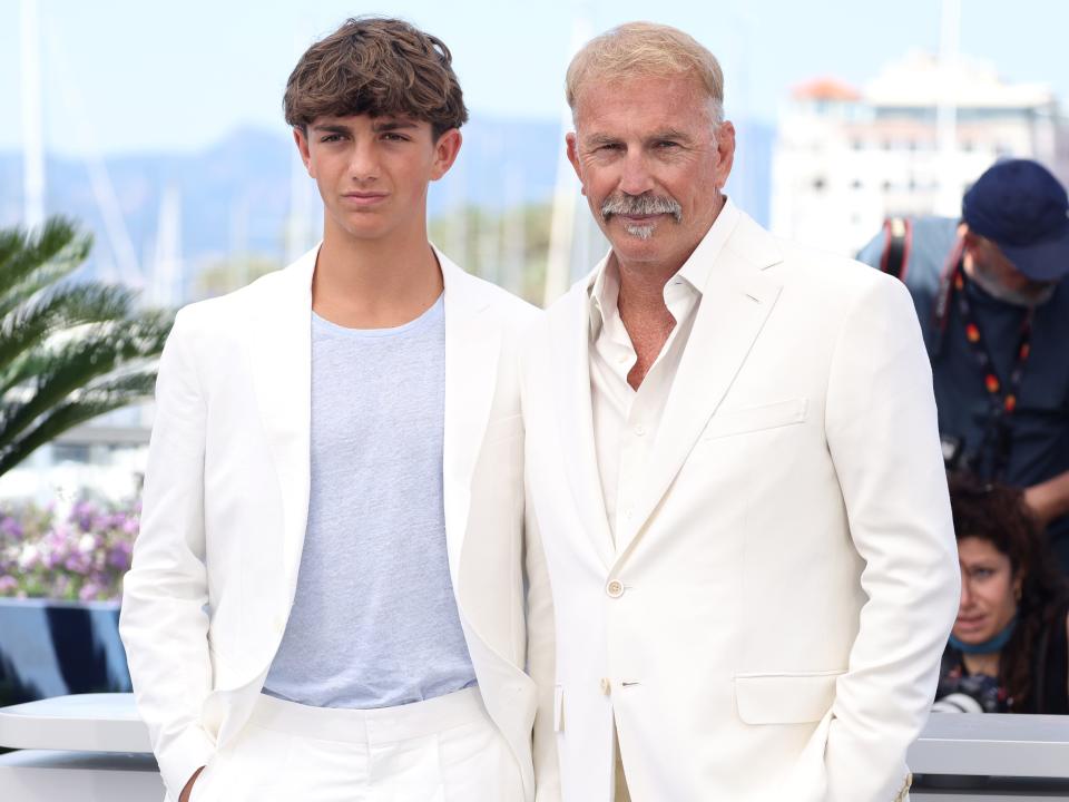 Hayes and Kevin Costner dressed in white jackets and pants