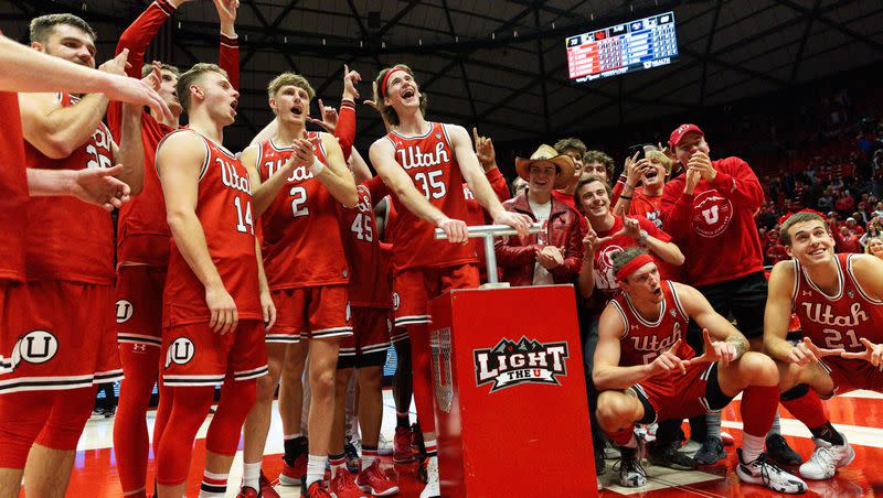 Utah Utes celebrate their victory over rival Brigham Young University during a men’s basketball game at the Jon M. Huntsman Center in Salt Lake City on Saturday, Dec. 9, 2023.