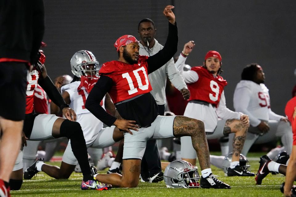 Mar 7, 2023; Columbus, Ohio, USA;  Ohio State Buckeyes wide receiver Xavier Johnson (10) stretches during spring football drills at the Woody Hayes Athletic Center. Mandatory Credit: Adam Cairns-The Columbus Dispatch