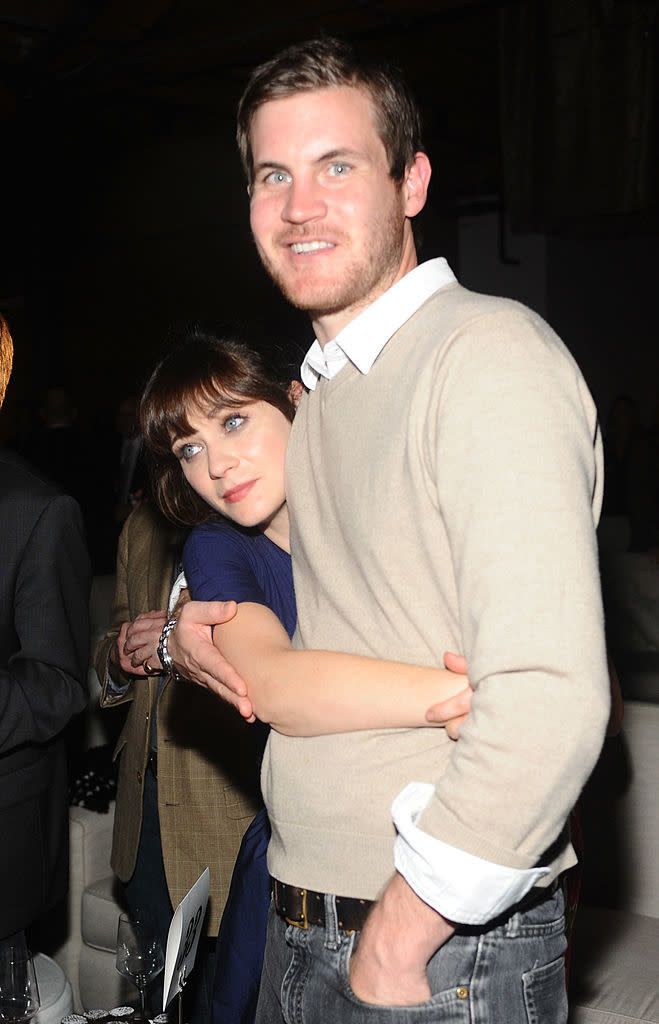 Zooey is hugging Jamie's waist and his arm is around her