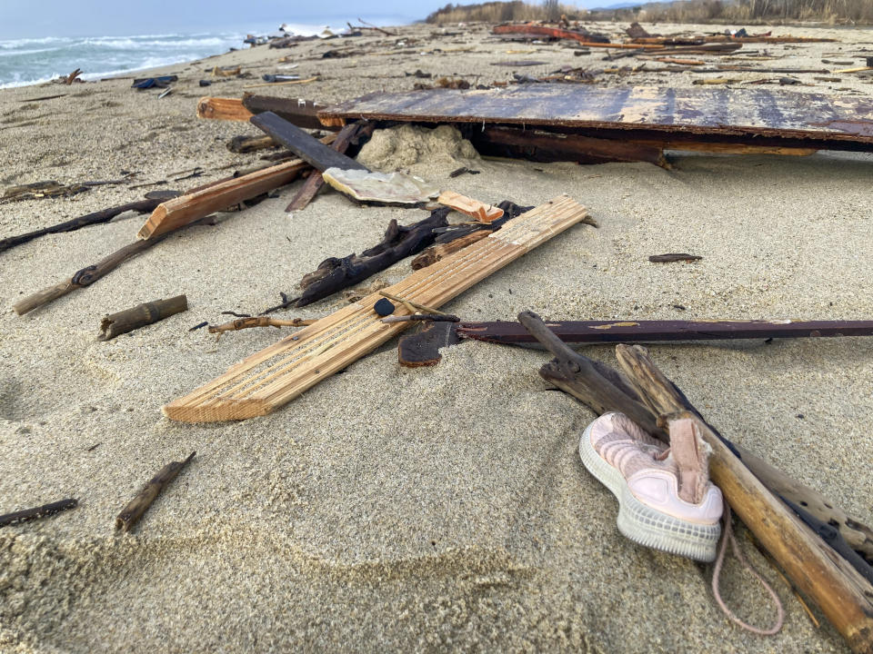 Personal belongings among the wreckage of a capsized boat washed ashore at a beach near Cutro, southern Italy, Monday, Feb. 27, 2023. Nearly 70 people died in last week's shipwreck on Italy's Calabrian coast. The tragedy highlighted a lesser-known migration route from Turkey to Italy for which smugglers charge around 8,000 euros per person. (AP Photo/Paolo Santalucia, File)