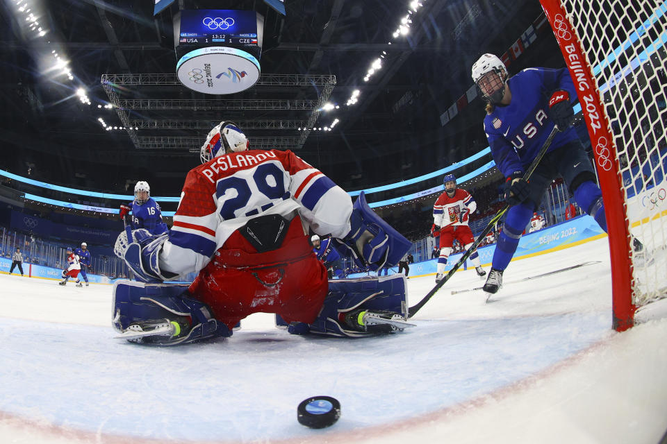 United States' Grace Zumwinkle (13), right, watches as a shot by teammate Lee Stecklein, not shown, gets past Czech Republic goalkeeper Klara Peslarova (29) for a goal during a women's quarterfinal hockey game at the 2022 Winter Olympics, Friday, Feb. 11, 2022, in Beijing. (Jonathan Ernst/Pool Photo via AP)