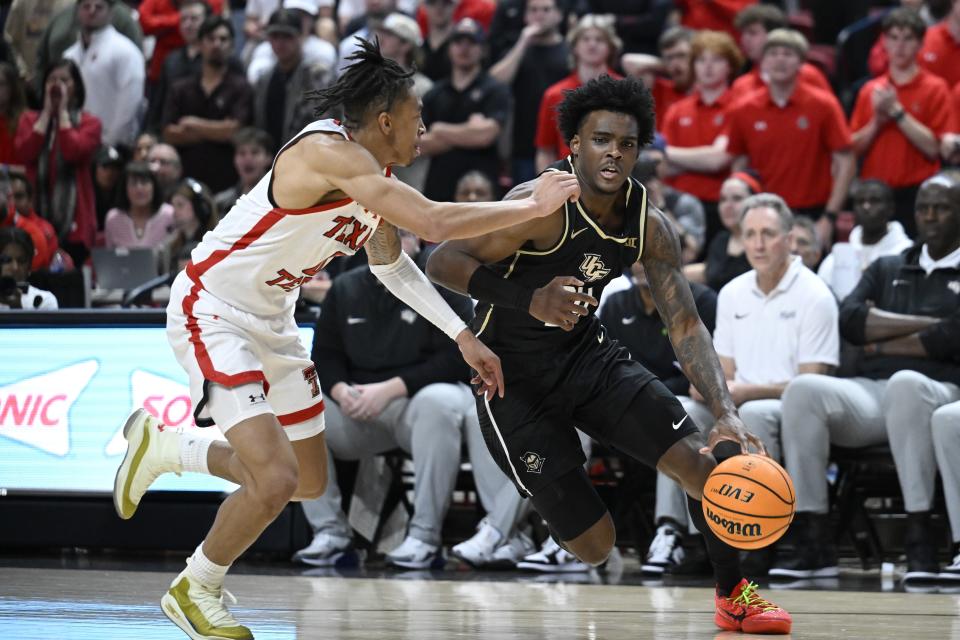 Central Florida guard Jaylin Sellers drives to the basket against Texas Tech guard Chance McMillian during the second half of an NCAA college basketball game Saturday, Feb. 10, 2024, in Lubbock, Texas. (AP Photo/Justin Rex)