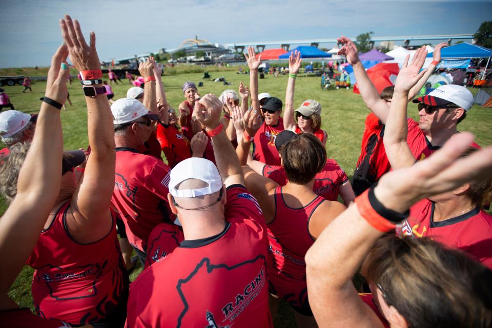 Team Arashi of the Racine Dragon Boat Club get pumped up at the seventh annual Milwaukee Dragon Boat Festival held at Lakeshore State Park in Milwaukee, Wisconsin on Saturday, August 10, 2019.