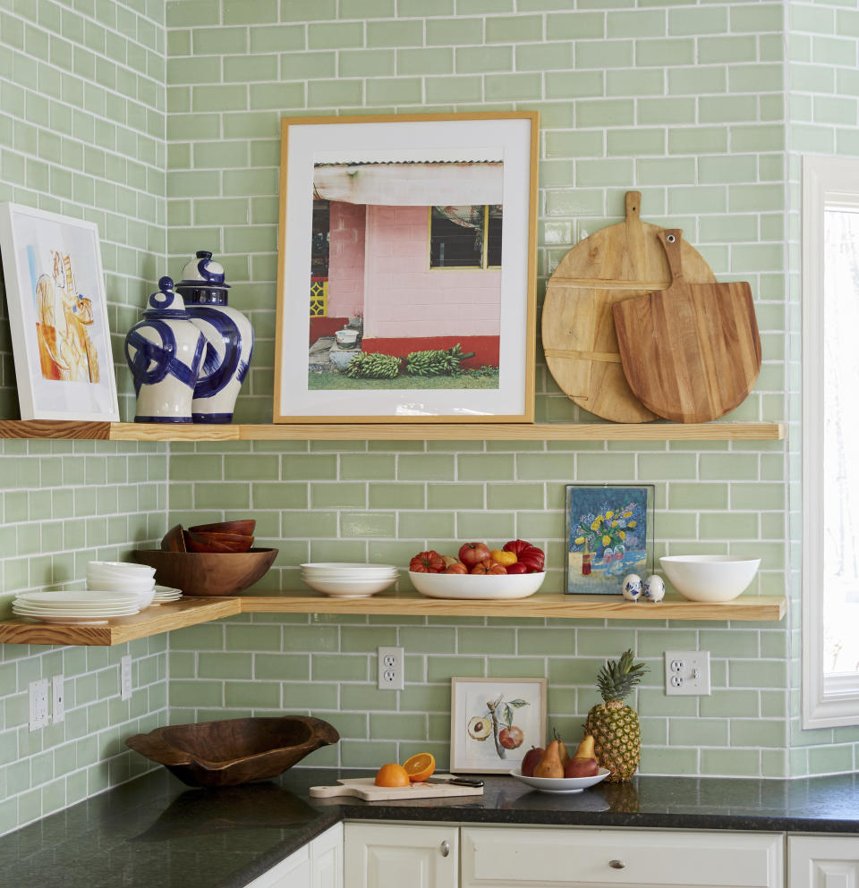 In this image provided by Better Homes & Gardens magazine, artwork is shown placed on shelves. It's an easy spring refresh -- no nails, drywall repair kits, or hanging equipment is needed. (Adam Albright/Better Homes & Gardens via AP)