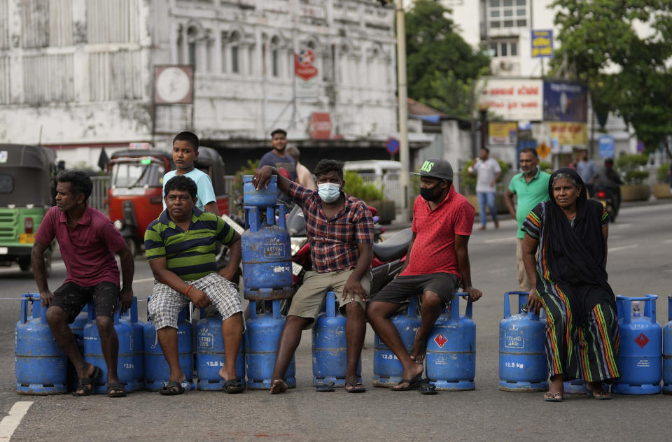 FILE - Sri Lankans block an intersection demanding cooking gas cylinders in Colombo, Sri Lanka, Saturday, May 7, 2022. International creditors should provide debt relief to Sri Lanka to alleviate suffering as its people endure hunger, worsening poverty and shortages of basic supplies, Amnesty International said in a statement Wednesday, Oct. 5, 2022. (AP Photo/Eranga Jayawardena, File)