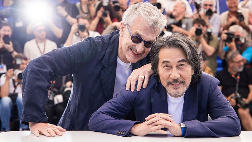 Director Wim Wenders, left, and Koji Yakusho pose for photographers at this year&apos;s Cannes Film Festival