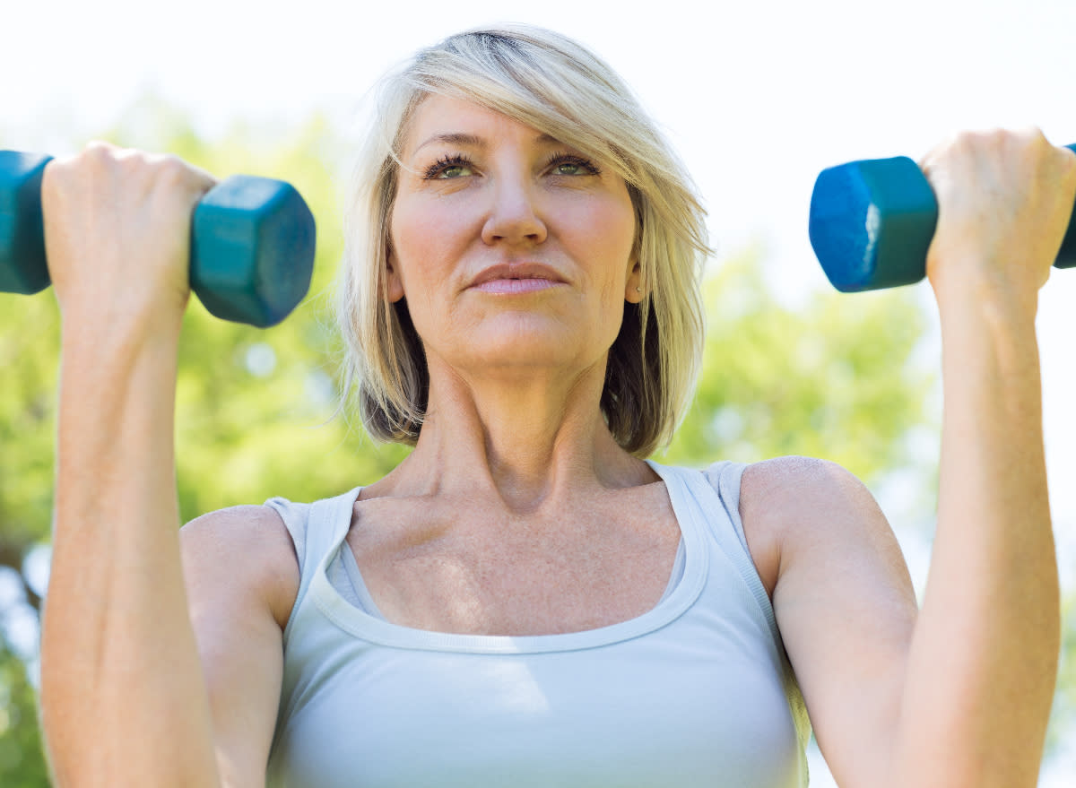 mature fit woman using dumbbells for workout