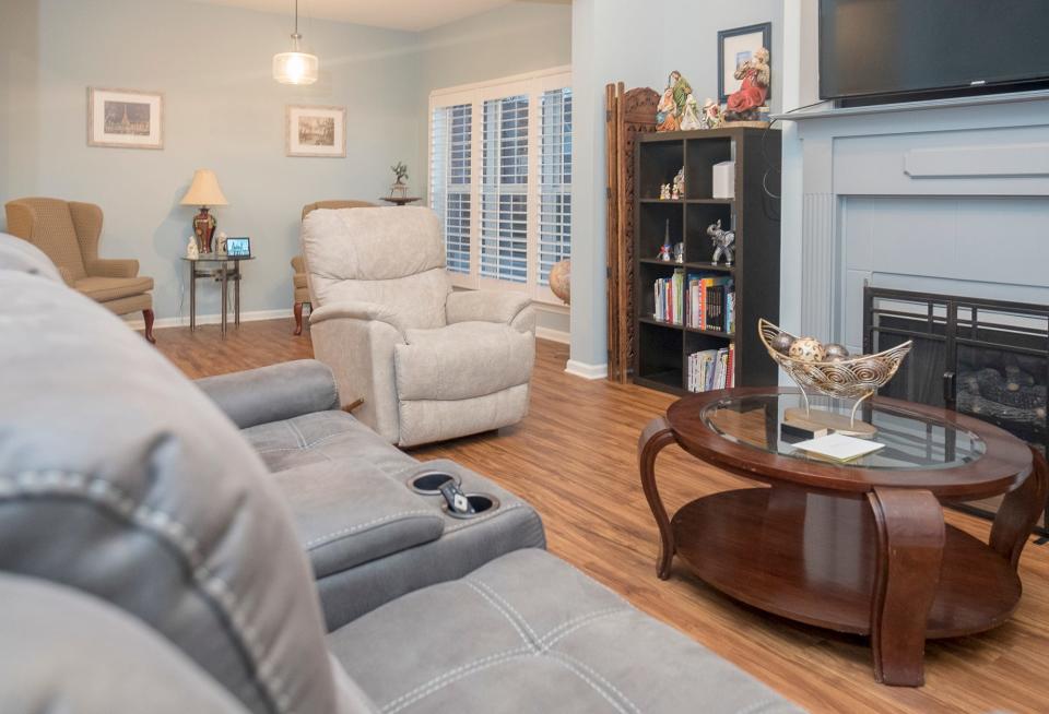 The living room is the entertainment center of the home and features a working fireplace, a large flat screen tv, and plenty of comfortable seating.