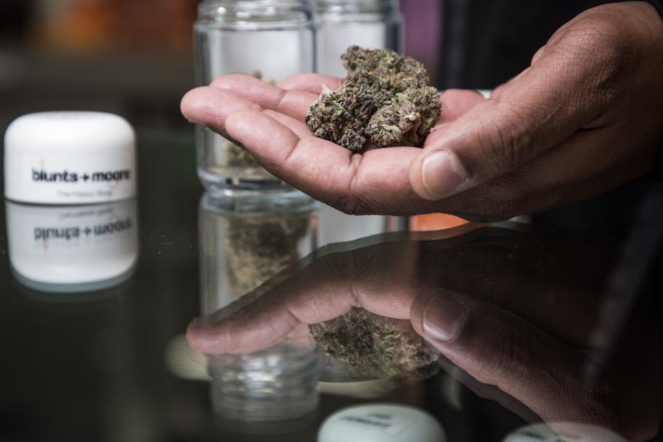 Displaying marijuana flower at a dispensary in Oakland, Calif.