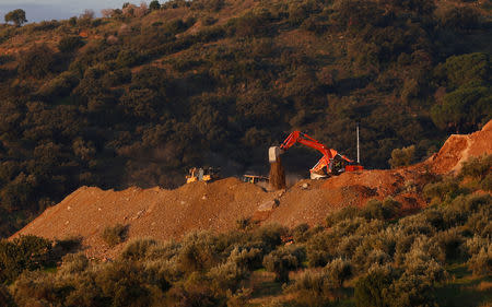 A digger pours sand next to the area where Julen, a Spanish two-year-old boy who fell into a 25-centimetre (9.8 inch) wide and around 100-metre (328 feet) deep well four days ago when the family was taking a stroll through a private estate, in Totalan, southern Spain, January 17, 2019. REUTERS/Jon Nazca