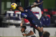 U.S. defender Kyle Duncan (16) heads the ball over El Salvador midfielder Narciso Orellana during the second half of an international friendly soccer match Wednesday, Dec. 9, 2020, in Fort Lauderdale, Fla. (AP Photo/Wilfredo Lee)