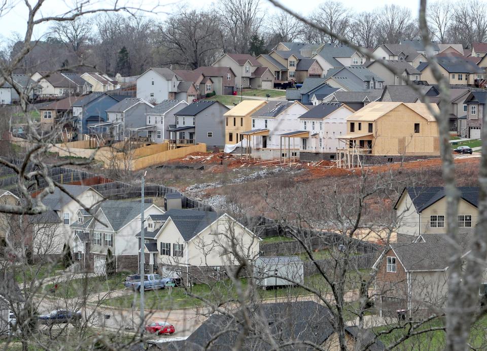 As seen from a vantage point off Peachers Mill Road, homes sit, some finished, some in the middle of construction, in a neighborhood in Clarksville, Tenn.