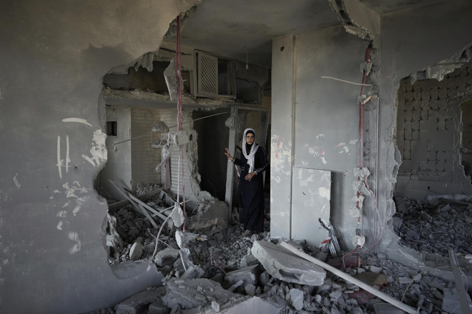 Adalah, the mother of Palestinian prisoner Kamal Jouri, inspects the ruins of the house belonging to the family which was demolished by Israeli troops in the West Bank city of Nablus, Thursday, June 22, 2023. Jouri is accused of shooting and killing an IDF soldier last year near Nablus. (AP Photo/Majdi Mohammed)