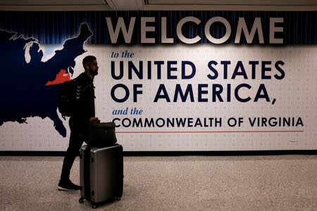 An international passenger arrives at Washington Dulles International Airport after the U.S. Supreme Court granted parts of the Trump administration's emergency request to put its travel ban into effect later in the week pending further judicial review, in Dulles, Virginia, U.S., June 26, 2017. REUTERS/James Lawler Duggan