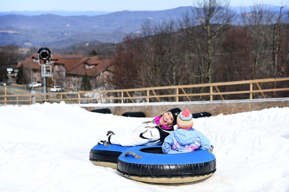Courtney Hilliard looks back at her daughter, Madeline, 5, of Cherryville, North Carolina, as they prepare to make their way down a tubing run at Beech Mountain Resort in Beech Mountain on Friday, Jan. 26, 2018.