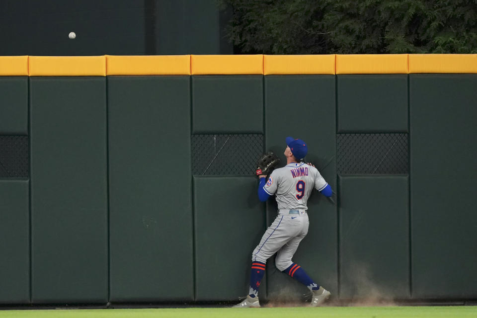 New York Mets center fielder Brandon Nimmo watches a ball hit for a home run by Atlanta Braves' Austin Riley clear the wall during the second inning of a baseball game Friday, Sept. 30, 2022, in Atlanta. (AP Photo/John Bazemore)