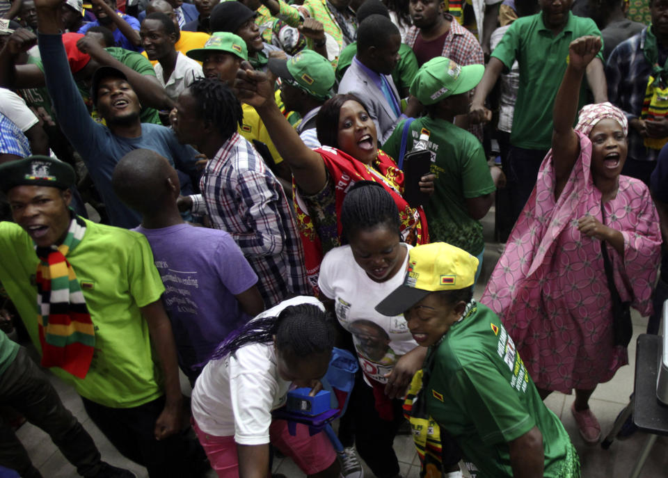 Supporters of Zimbabwean President Emmerson Mnangagwa celebrate in Harare, Friday, August, 24, 2018. Zimbabwe's constitutional court on Friday unanimously upheld Mnangagwa's narrow victory in last month's historic election after the opposition alleged vote-rigging, saying "sufficient and credible evidence" had not been produced. That means the inauguration will be held within 48 hours, likely on Sunday, as Zimbabwe moves into a new era after Robert Mugabe's 37-year rule.(AP Photo/Tsvangirayi Mukwazhi)