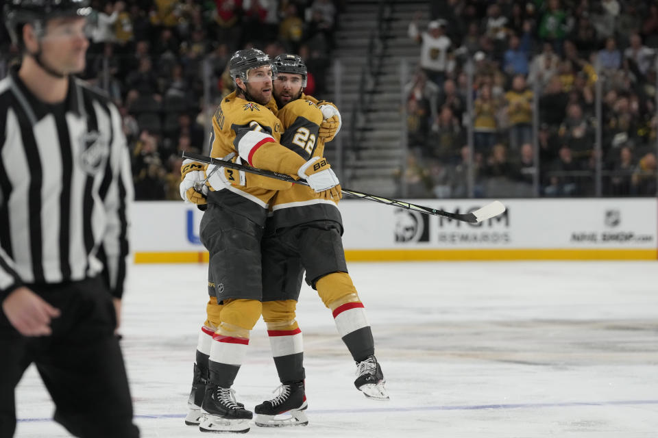 Vegas Golden Knights right wing Michael Amadio (22) celebrates with defenseman Alex Pietrangelo (7) after scoring against the Vancouver Canucks during the second period of an NHL hockey game Thursday, March 7, 2024, in Las Vegas. (AP Photo/Lucas Peltier)