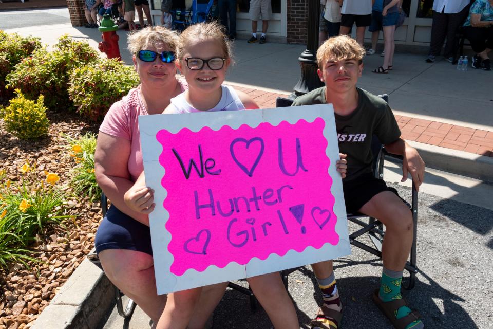 Christina, Cassidy and Daniel woods pose with their sign to show support for Winchester’s homegrown talent on Tuesday, May, 17, 2022, during the HunterGirl Homecoming.