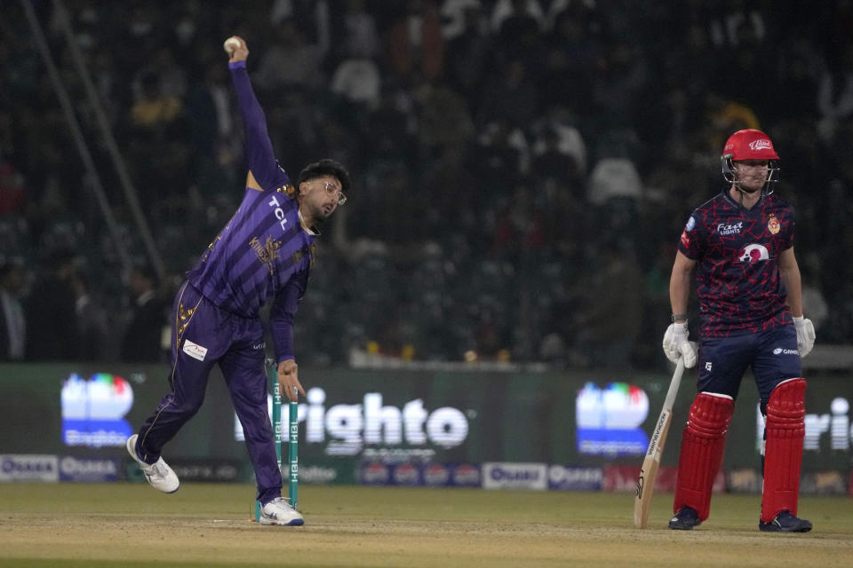 Quetta Gladiators' Abrar Ahmed, left, bowls as Islamabad United Jordan Cox watch during the Pakistan Super League T20 cricket match between Islamabad United and Quetta Gladiators, in Lahore, Pakistan Thursday, Feb. 22, 2024. (AP Photo/K.M. Chaudary)