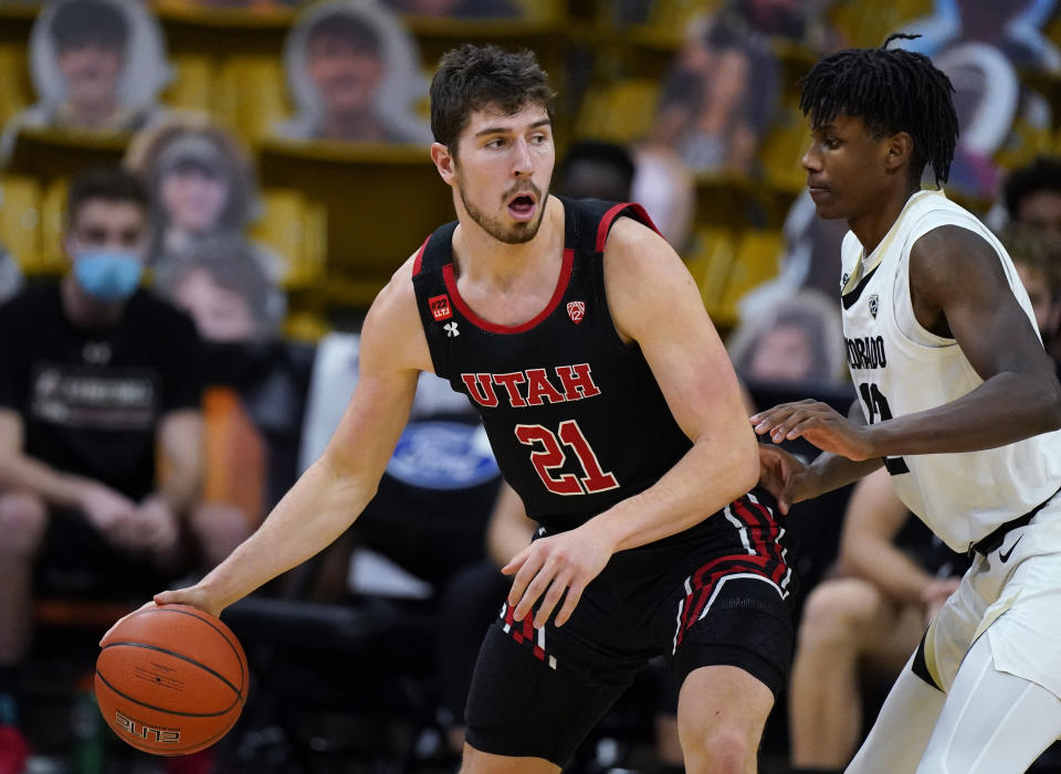 Utah forward Riley Battin, left, looks to pass the ball as Colorado forward Jabari Walker defends in the second half of an NCAA college basketball game Saturday, Jan. 30, 2021, in Boulder, Colo. (AP Photo/David Zalubowski)