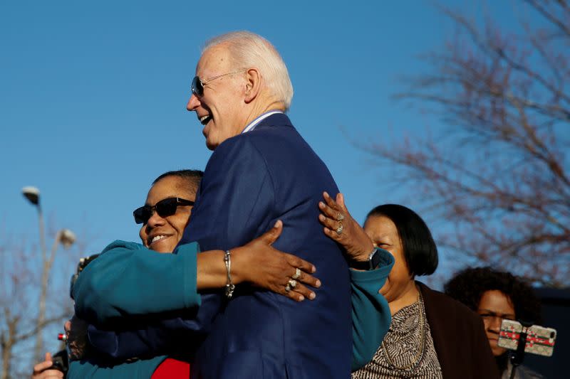 Democratic U.S. presidential candidate and former U.S. Vice President Joe Biden receives a hug from a supporter outside a polling site in Greenville