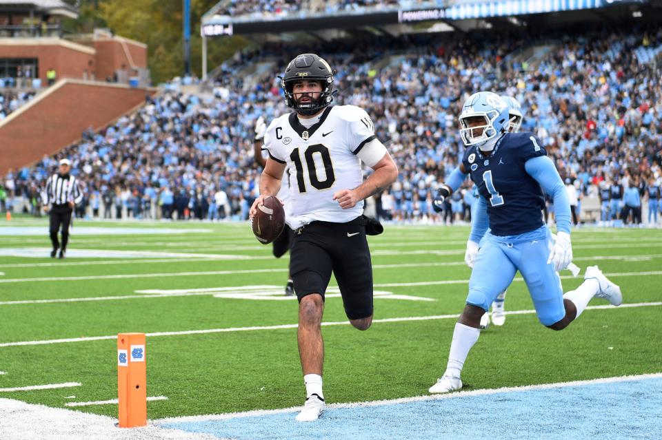 Sam Hartman scores a touchdown for Wake Forest during his team's game against North Carolina at Kenan Memorial Stadium in 2021.