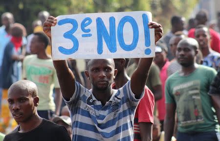 A protester holds a placard as they demonstrate against the ruling CNDD-FDD party's decision to allow Burundian President Pierre Nkurunziza to run for a third five-year term in office, in Bujumbura, May 4, 2015. REUTERS/Jean Pierre Aime Harerimana