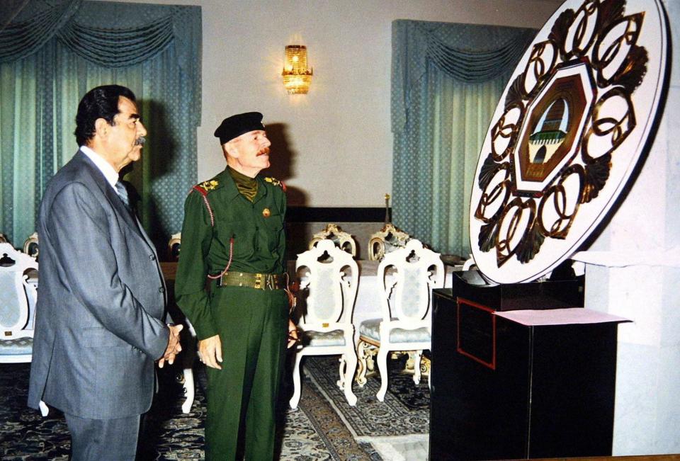 Saddam Hussein and al-Douri inspect an artwork depicting the Muslim shrine in Jerusalem, the Dome of the Rock - Iraq News Agency/AFP via Getty Images